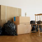 3D rendering of cardboard moving boxes on the floor in empty room